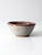 Vintage handmade studio pottery bowl featuring a softly rounded form, speckled gray glaze, and a rich mauve interior. The...