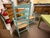 20th century pair of ladder back arm chairs. Mushroom cap arm holds and top detail. Rush seats. These chairs have been...