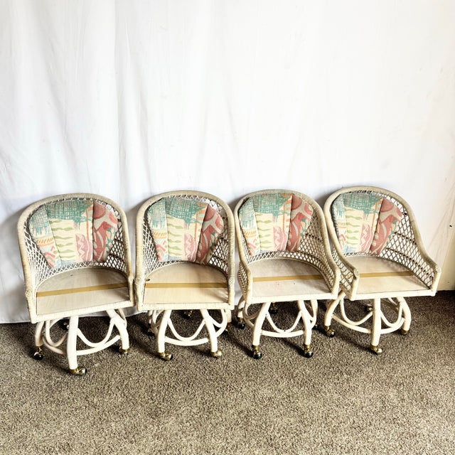 This charming set of four Boho Chic swivel dining chairs features woven buri rattan frames in a soft beige tone with...