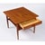 A well-proportioned pair of Danish lamp tables in solid teak, each raised on gently tapered, round turned legs with a...