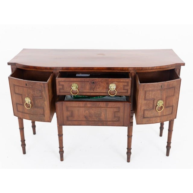 An exceptional Regency period mahogany sideboard of elegant and imposing proportions, raised upon six finely turned and...