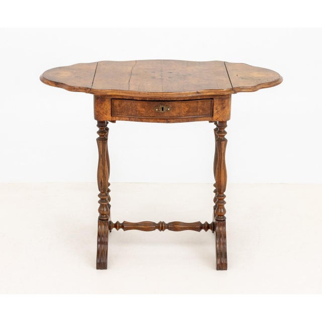 Victorian Burl Walnut Pembroke Table, with serpentine top and drop-leaf sides above single drawer on four turned supports...
