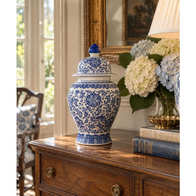 A classic blue and white ginger jar, decorated throughout with delicate Chinoiserie floral motifs. The pattern is dense...