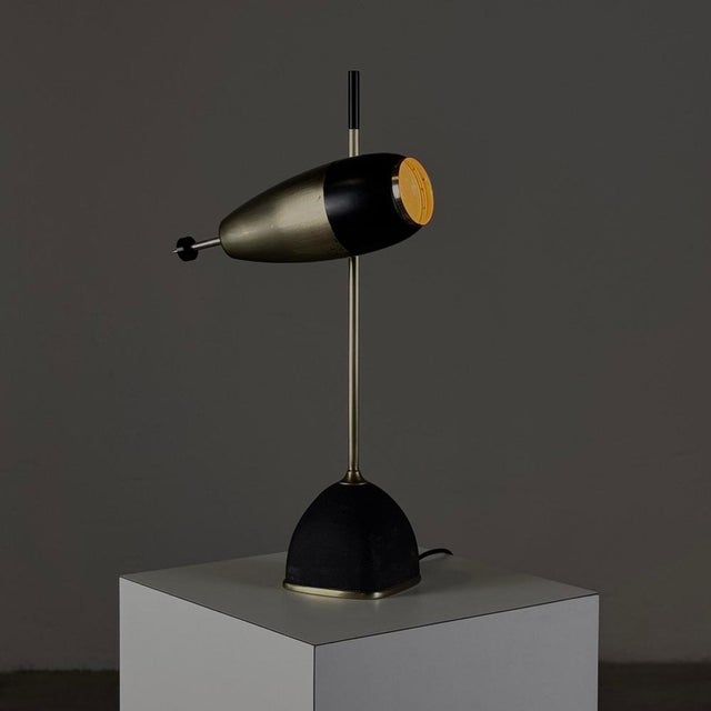 This rare and iconic model 577 table lamp by oscar torlasco for lumi milan is a testament to the refined design ethos of...