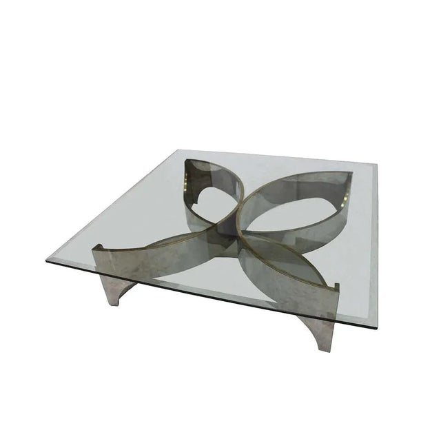 Center table attributed to frank stella with flower-shaped chrome metal structure and transparent glass top. Usa 80's....
