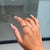 This Modern Wavy Band Ring features 0.10 carat natural marquise-cut emerald, set in 14k yellow gold. The marquise cut...