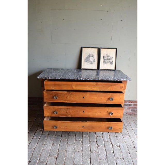 19th-century Dutch walnut chest of drawers, sideboard, commode. with a grey marble top. The height is 91 cm. The width is...