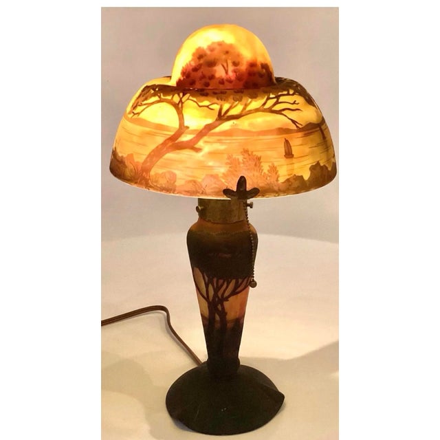 The highly prized original Daum Nancy table lamp is signed and accompanied by the Cross of Lorraine mark. It is French Art...