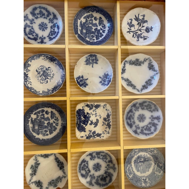 12 antique butter pats framed in a wooden shadow box which was part of my blue and white collection. Also listed at...