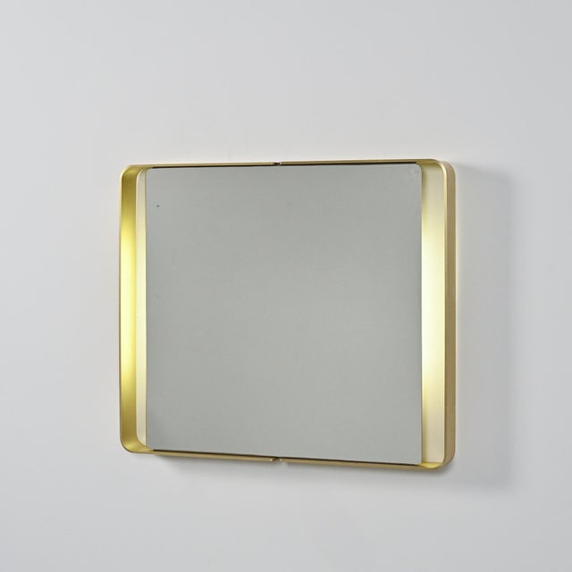 Rectangular mirror from the 1970s, framed in folded gold-tone metal with a continuous, rounded edge. Its simple, elegant...