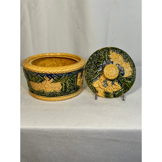 Welcome to Turtle and Crane! Let us introduce to you a Vintage Mid-Century Majolica Green and Yellow Biscuit Container...