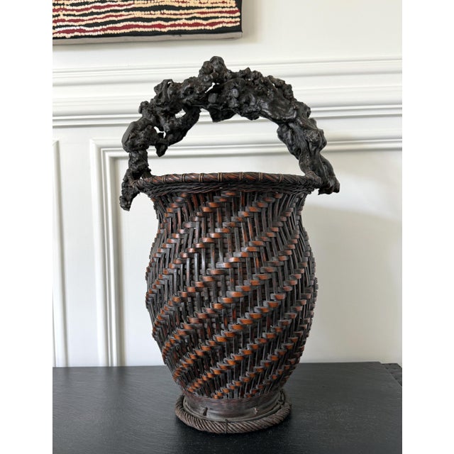 An extraordinary Japanese bamboo flower basket (ikebana) with a bespoken sculptural handle dated to the late 19th century...