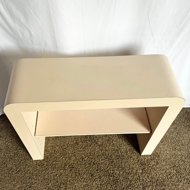 With its sleek waterfall silhouette and soft blush tone, this Postmodern Light Pink Laminate Console radiates minimalist...