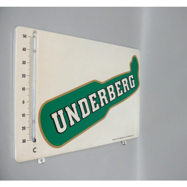 A decorative metal sign “Underberg” with a thermometer for the range -30 to + 50 °C. The thermometer is functional. The...