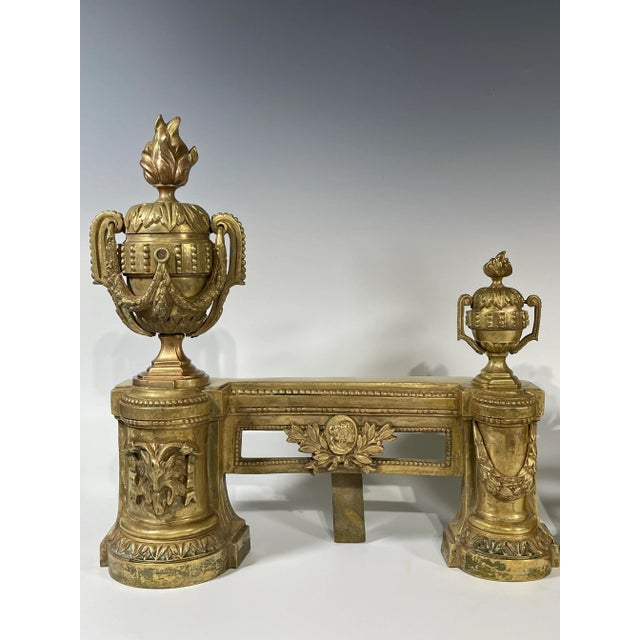 This pair French fire andirons are 19th century, Louis XVI style. The heads of andirons are each decorated with an urn on...