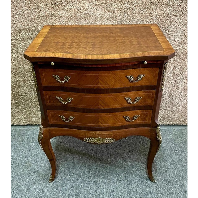 Vintage Three Drawer Chest has a French Style. The Chest is made of Wood. Walnut. Parquet Top, Inlaid Wood, and Brass...
