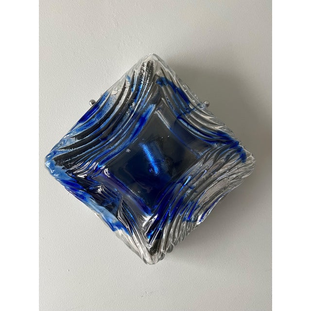 Stunning and unique pair of italian blue clear thick murano glass wall sconces by mazzega. These fixtures were designed...