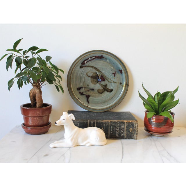 Vintage studio art pottery plate. Signed by artist on bottom. Minor age wear. No chips or cracks.