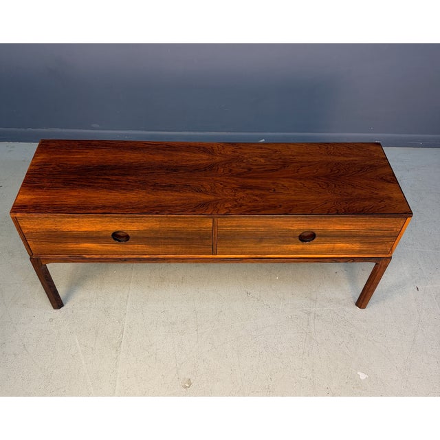A refined Danish modern low chest designed by Kai Kristiansen, model 394 from his “Entre” series, produced by Aksel...