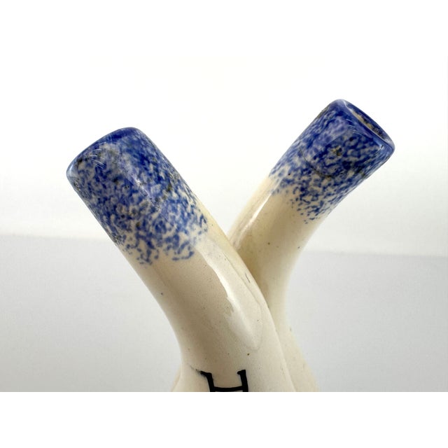 This early 20th century HB Quimper double cruet features the classic Breton figure rendered in traditional hand-painted...