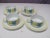 Set of four cups and saucers by RICHARD GINORI. The cups feature yellow and teal colored flowers of a white ground. This...
