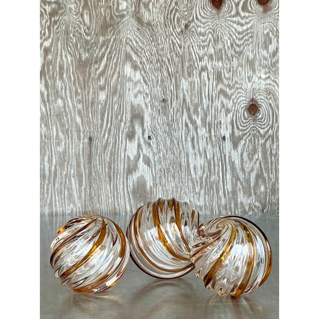 Add a sophisticated swirl of style to your space with this trio of Vintage Regency Caramel Swirl Blown Glass Spheres....