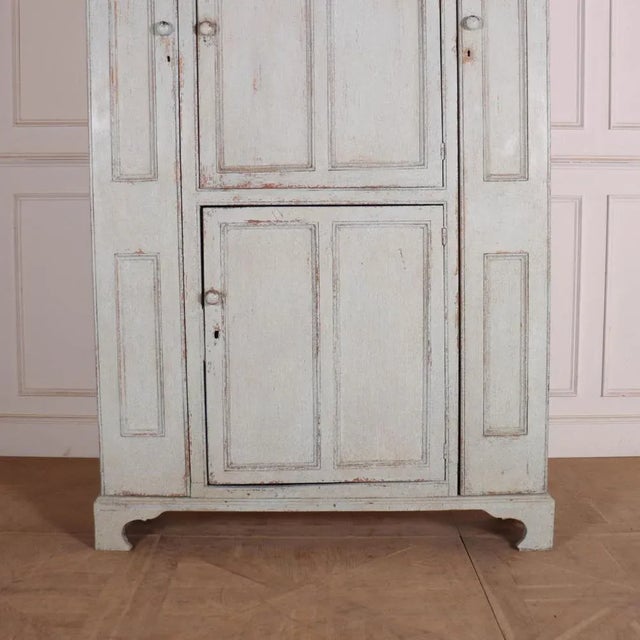 Unusually small 4 door English painted pine housekeepers cupboard. 1810. This piece is designed in the style of the...