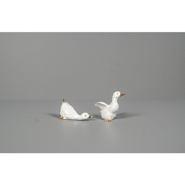 2 porcelain ducks from the 70s. The 2 ducks of different sizes are hand-made, with mother-of-pearl coloring and with gold...
