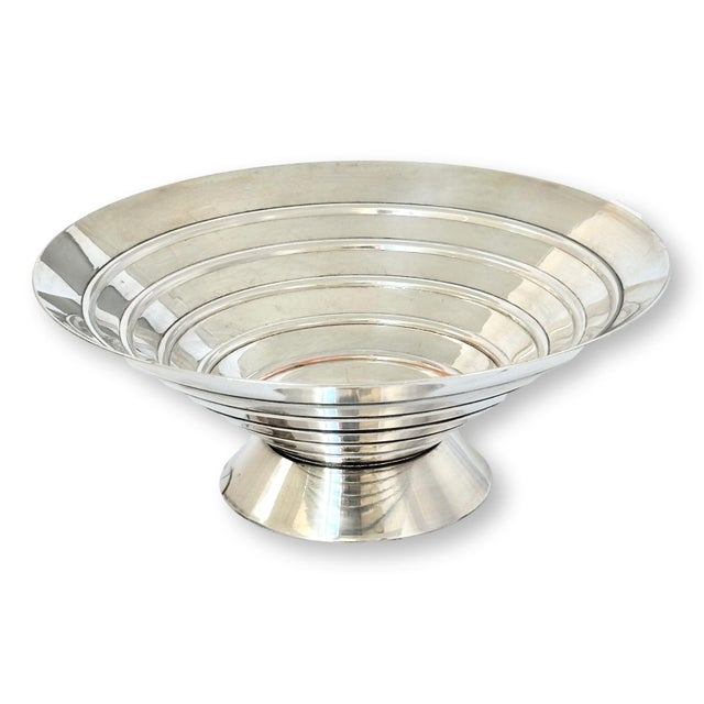 A bold example of Art Deco design, this English silver-plated centerpiece bowl features dramatic stepped banding, a flared...
