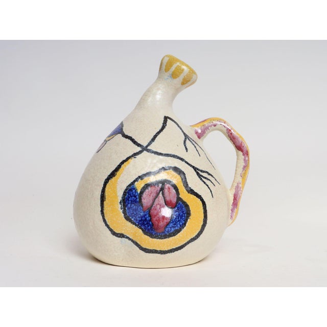 Circa 1946 Art Deco ceramic pitcher/jug from Gouda, Holland in the "Espera" pattern. Bulbous, amorphic form with a...