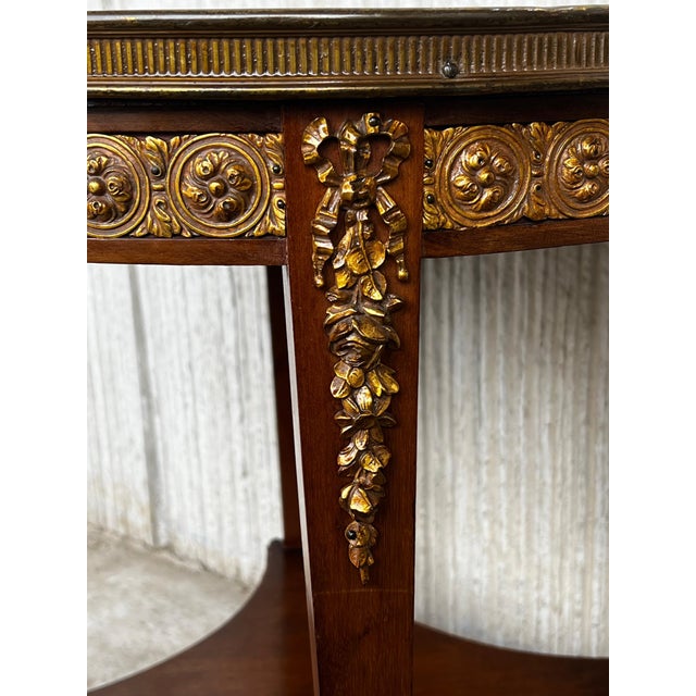 20th century Louis XVI style with bronze and round marble French oak wood table. Solid oak with partial veneer and finely...