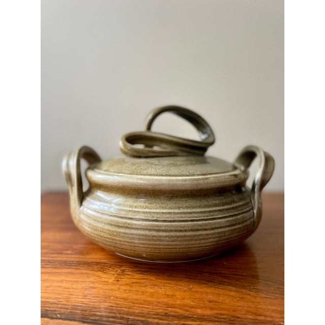 An absolutely stunning work of Studio pottery, presented in a soft pea green with tiny chocolate brown specs throughout...