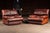 Pair of oversized leather lounge chairs with broad padded arms, deep seat cushions, and low block wood feet. Subtle panel...