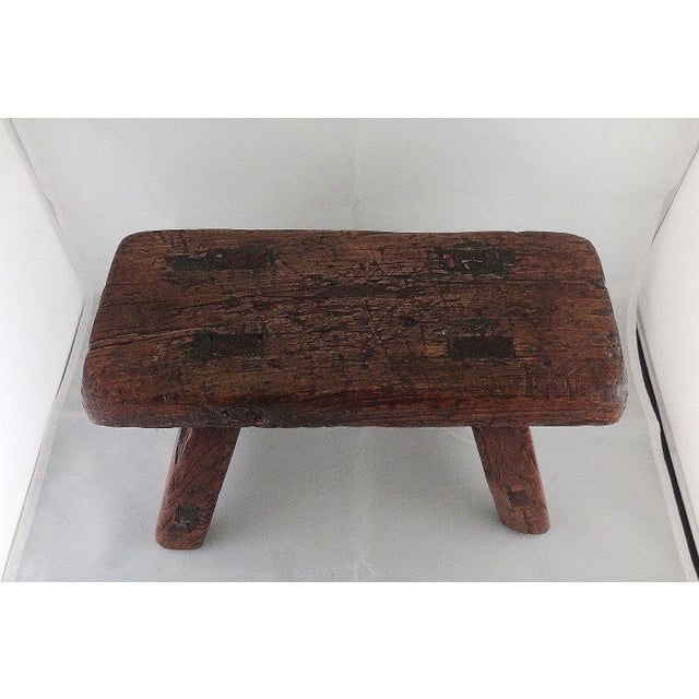 A handmade, rustic, footstool from the 19th century made with Mortise and tenon joints. The smooth, shiny patina with many...