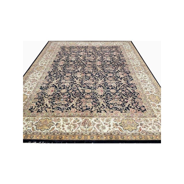 Enhance your space with the captivating beauty of this 10x14 Handwoven Indian Agra Area Rug. Handwoven in the Agra region...