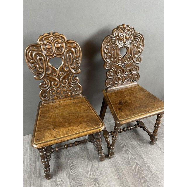 Pair of Baroque-Style Carved Wooden Chairs Exquisite pair of chairs, embodying the splendor and sophistication of the...