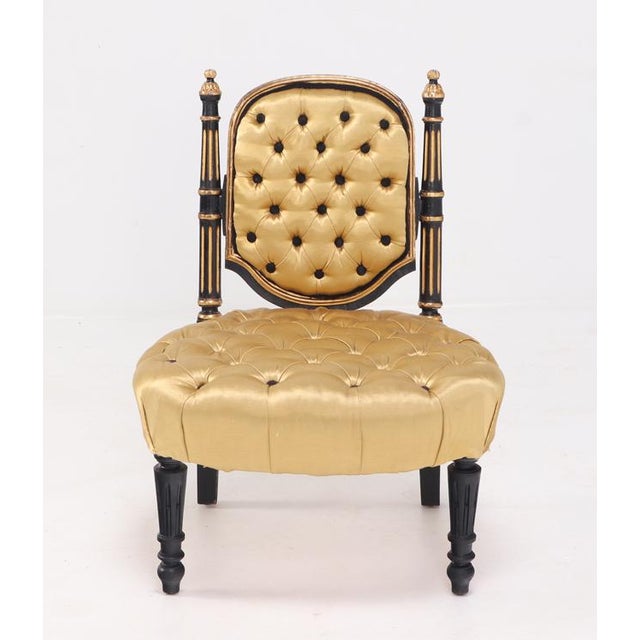This elegant, low-profile slipper or bedroom accent chair features an exquisite deeply button-tufted upholstery in a...