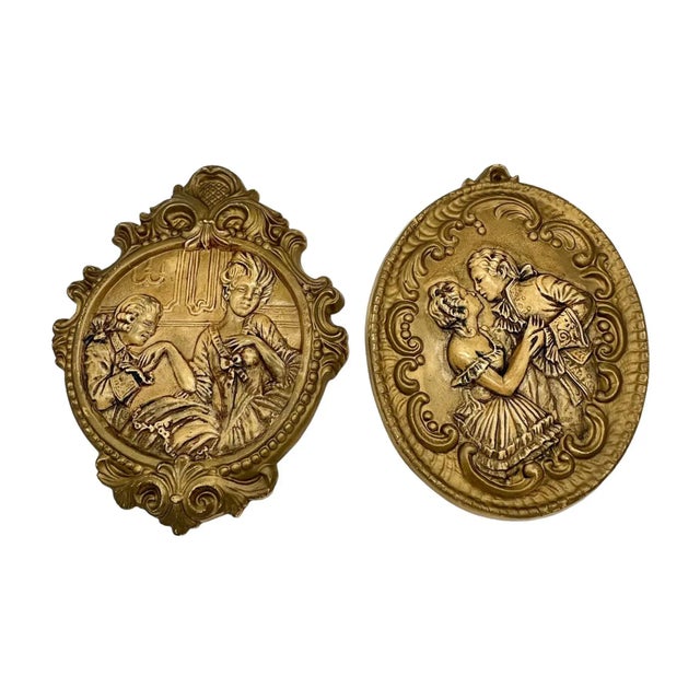 Stunning pair of French revival gilt wall plaques featuring a lord and lady’s courtship.