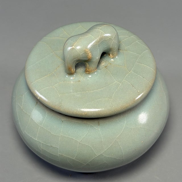 Fine antique Chinese celadon covered jar. Bulbous rounded body paired with matching lid decorated by sculpted animal...