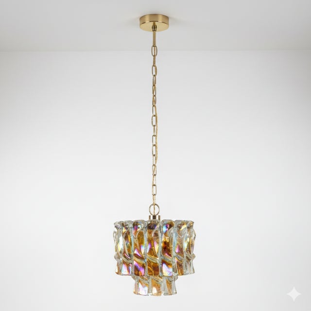 This Murano glass and metal chandelier, attributed to Gino Vistosi and dating to the 1960s, features hand-blown iridescent...