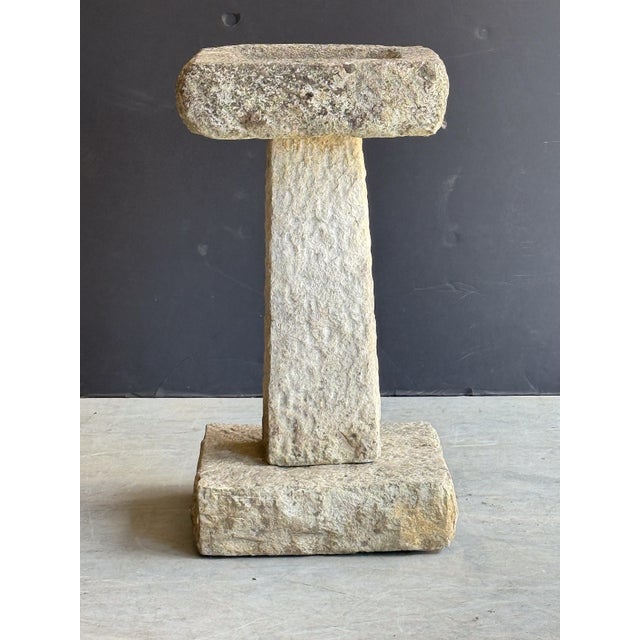 A fine English garden bird bath of composition stone, featuring a square top with round recessed bath area in the center,...