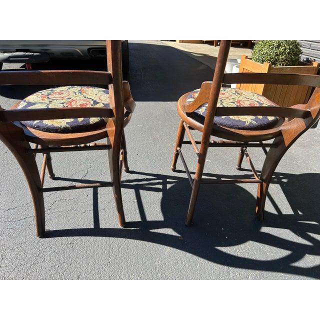 Pair of dark walnut wood and wool needlepoint chairs. These are perfect for a dining setting, desk or occasional chair....