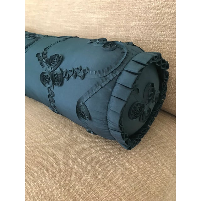 Pair of bespoke, round bolsters with flat endcaps, piano key flange, and hidden zipper closure. Fabric is a peacock blue...