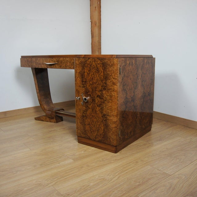 An Art Deco Desk by F.Pigeon of Paris. Burr walnut veneered throughout with mahogany lined drawers and original shaped...
