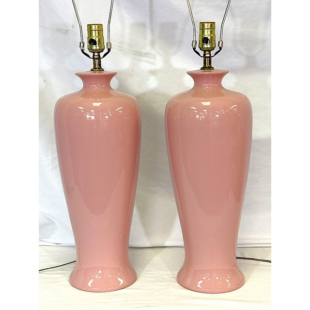 Great pair of vintage ceramic lamps from the mid 20th century. These have a pretty Barbiecore pink that goes well with...