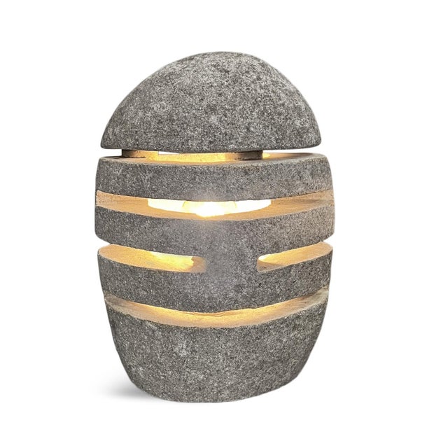 Solid stone river rock table lamp with laser cut designs throughout. Each is unique and varies slightly in size and shape....