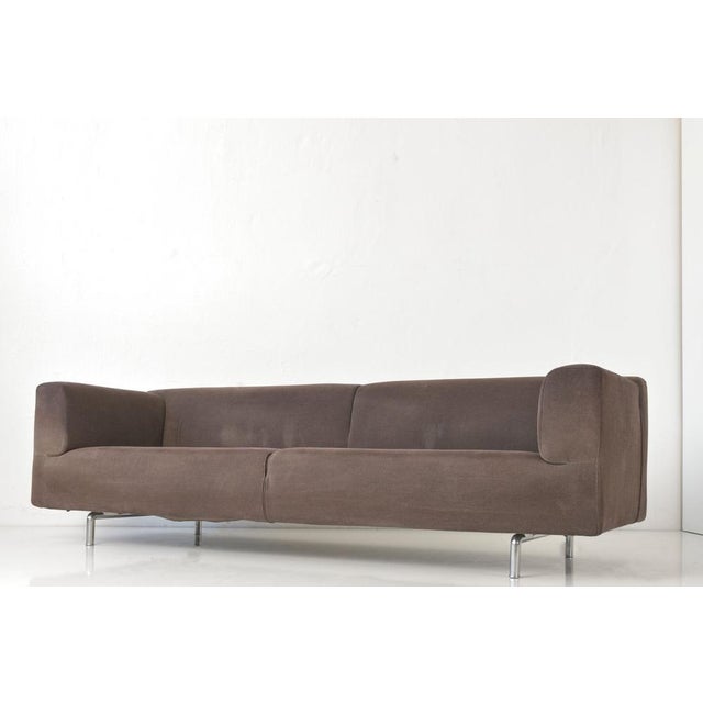 The linear MET 250 sofa by Piero Lissoni is covered in a cosily warm, dark brown pile fabric cover. The large size, the...
