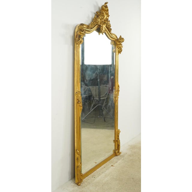 19th century Louis XV style mantel mirror made of gilt wood with plaster cherubic figures on each of the top corners. The...