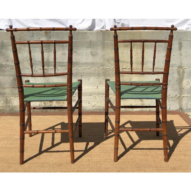 Elegant 19th C faux- bamboo turned wood side chairs with natural rush seats. There are canvas covers for both seats. Note...
