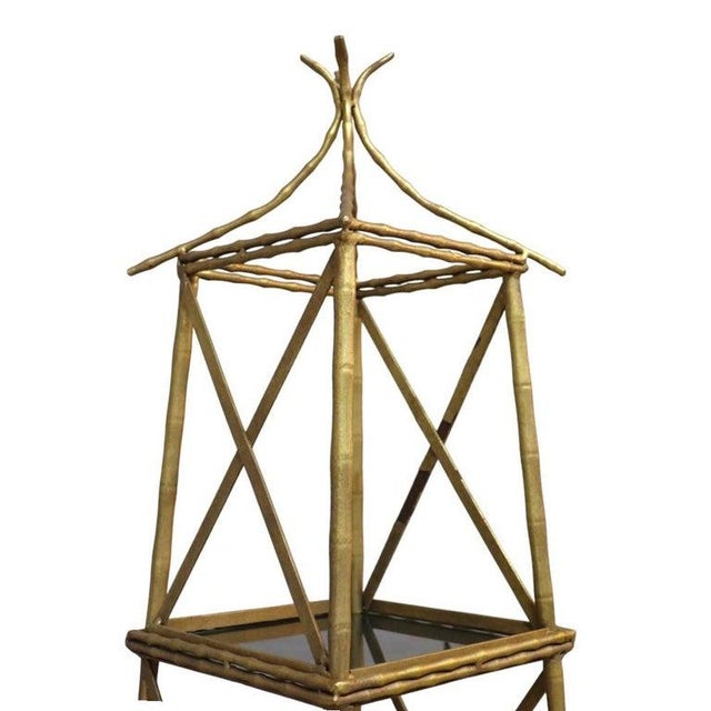 This pagoda form set features five individual stacking side stands or etagere when essembled, crafted from brass and...